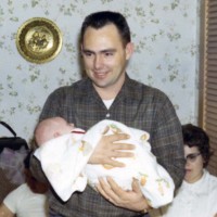 Joe, in his home, holding me at my first Christmas in 1968.